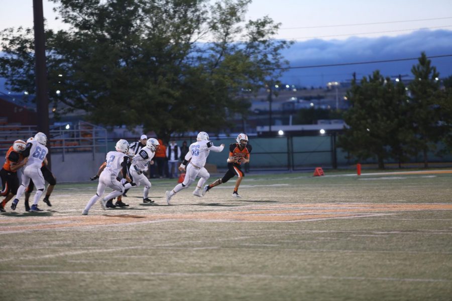 Pulling away:
Junior #12 Harrison Taubert sprints away from the Cheyenne East Thunderbirds during the 2019 Homecoming football game. Taubert would go on to facilitate many of the points scored by the mustangs during the game. The mustangs ended up winning 38-35 in double overtime.