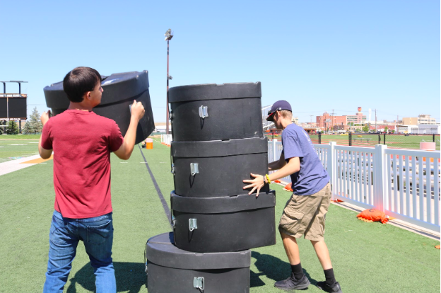 Working together :
Drumlympics team members Nick Vincent (11) and Alex Bryan (10) work together to stack the bass drum cases as quickly as possible in the bass case stacking event at the 2019 Drumlympics. 