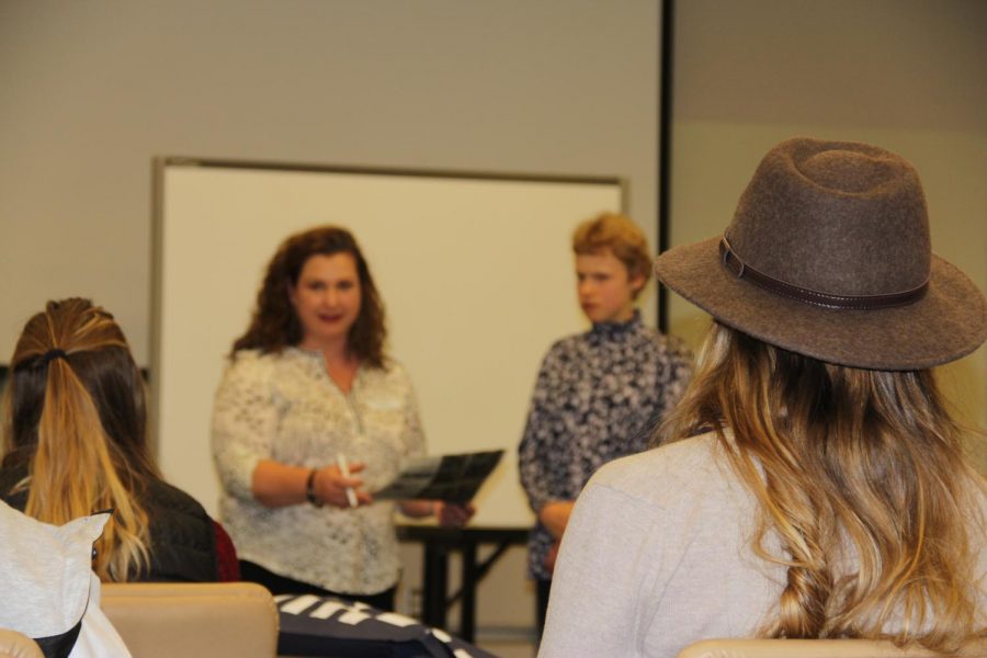 Jackson Hole News editor Joanna Love reviews students work at the WHSSPA Journalism Convention.