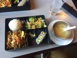 This lunch special has red curry , miso soup, salad, california rolls, and rice. 