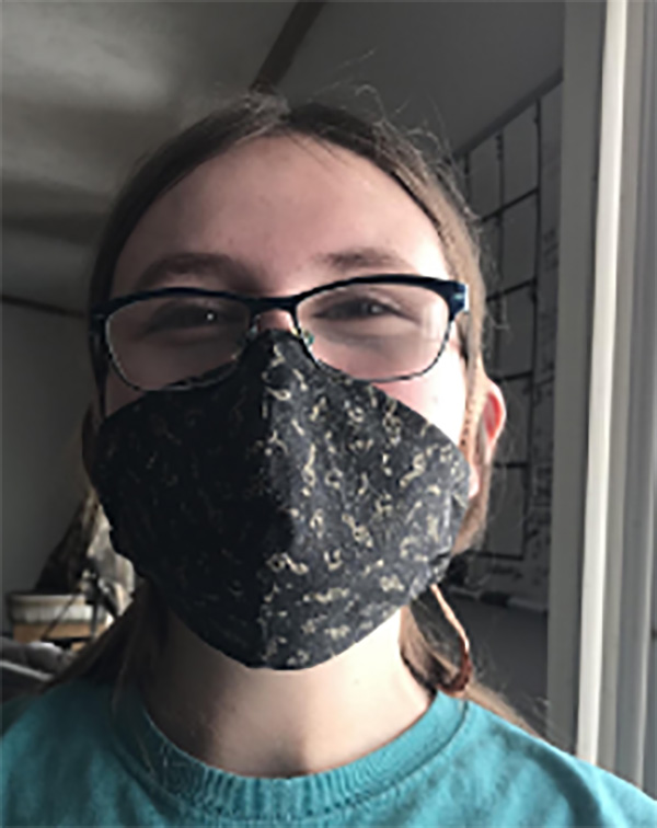 Maya Cooper models the mask she made to protect herself and her family during Covid-19.
