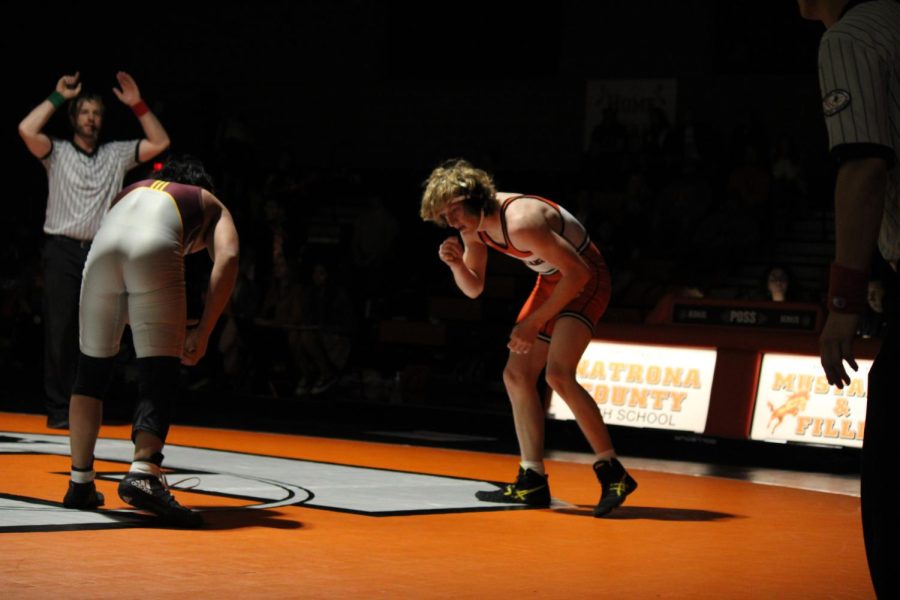 wrestler sizing up opponent