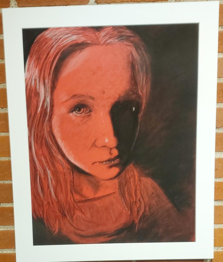 Charcoal+portrait+of+a+young+girl+on+red+toned+paper.