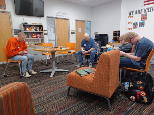 Volunteer Cody Wagner (far left) for Casper Youth for Christ led students in prayer, during 1st lunch. Youth for Christ meets at NC every Thursday for both lunch periods, offering free food and a chance to study the Bible.  