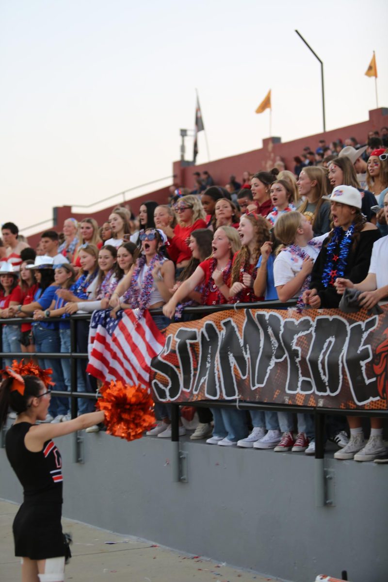 Natrona fans cheer on their team at the season opener against Thunder Basin on August 27, 2024. All students are considered part of the "Stampede," but the Stampede club is specifically devoted to coming up with game night themes and making sure the student section is packed with enthusiastic fans. "I think it's gone on for years. I remember going with my siblings and they would have a big student section," said Delaney Oden.