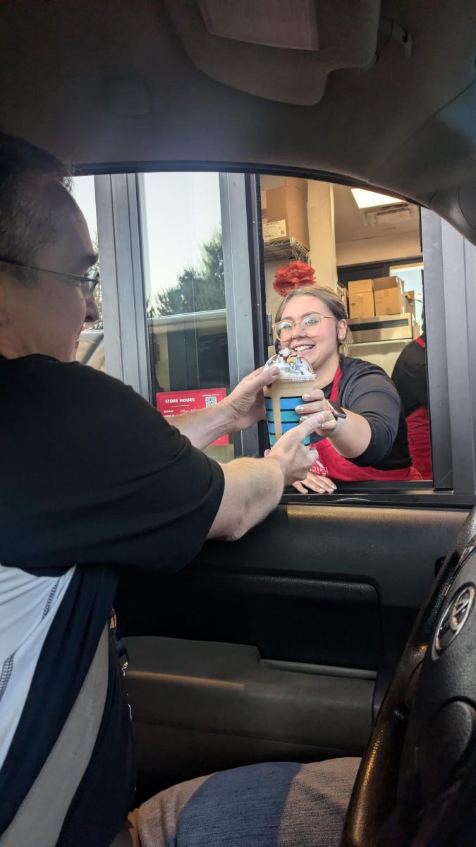 Aster Harrison hands Carl Myers a peanut butter frappuccino at Scooters. Harrison was a former NC student, but now works at Scooters. Scooters is within walking distance of NCHS and is popular with many students.
